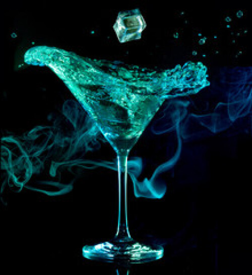 Image of ice falling in a splashing cocktail isolated on smoky dark background. printed on Printed Glass Splashbacks